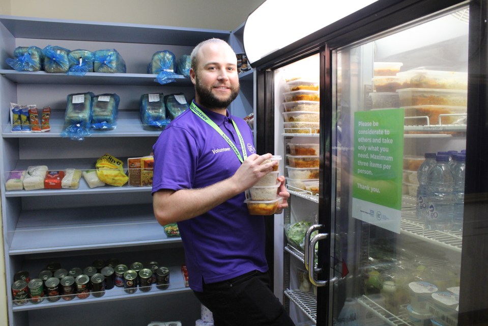  Volunteer Alistair Baldwin stacking ready meals in the charity-funded shop at Charing Cross Hospital