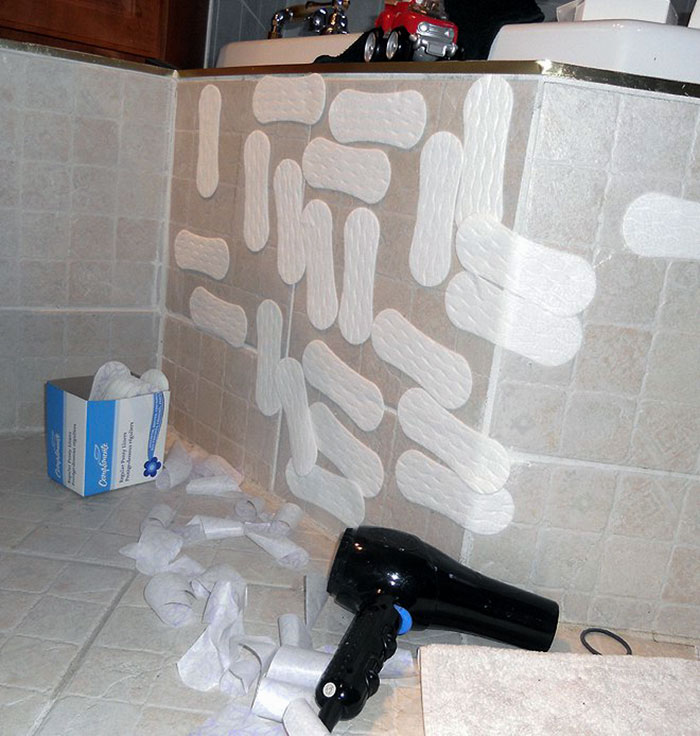 This child wrecked the bathroom by throwing Mum's sanitary towels everywhere