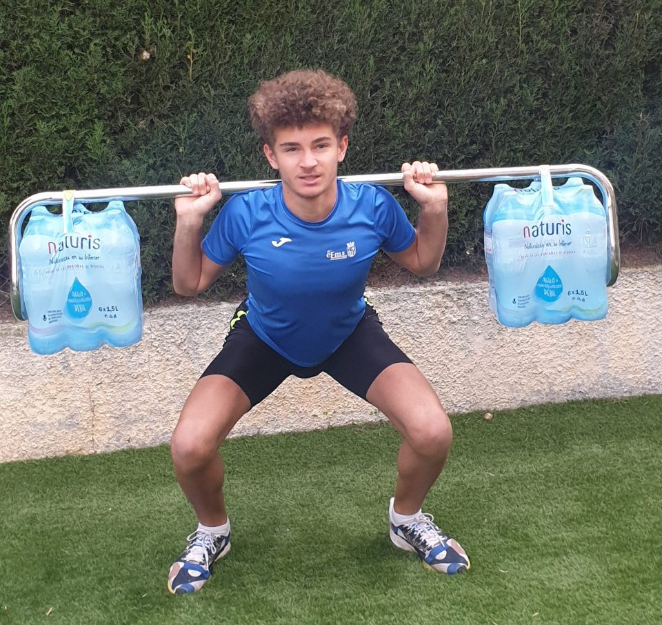  Isaac lifts 'weights' using a clothes rail with water bottles attached