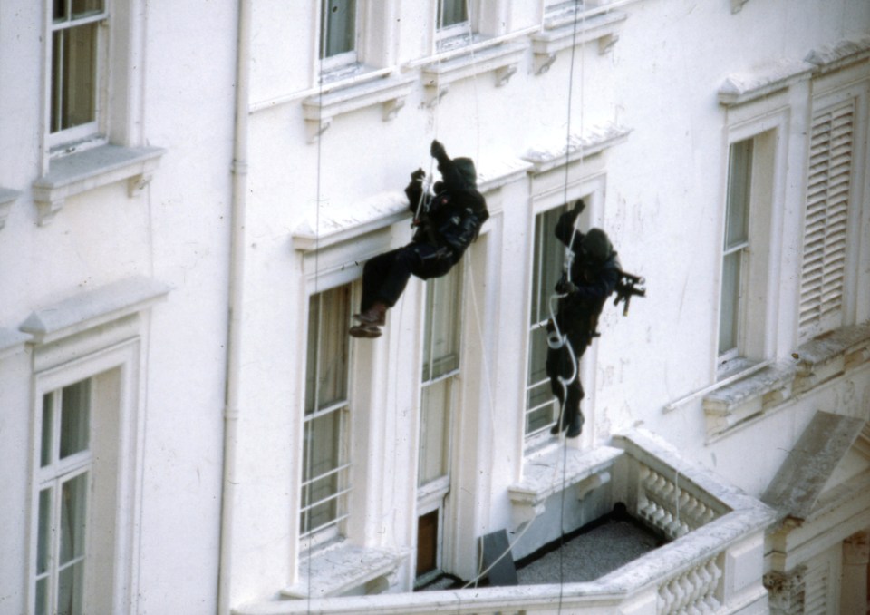 The hero soldiers abseil down from the roof before entering the building through the windows