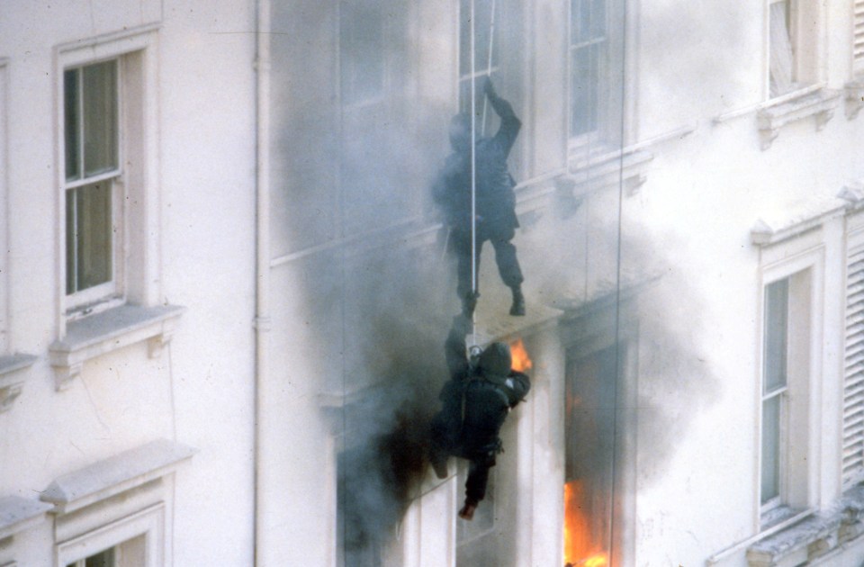 Fire rages inside after the soldiers dropped an explosive through the roof’s skylight to cover their entrance