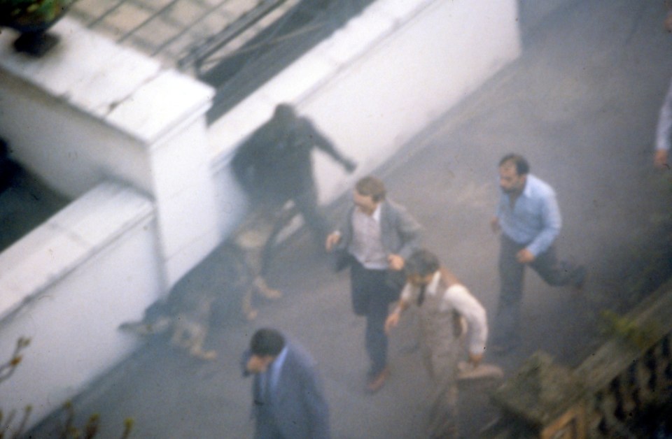 The hostages are seen running through smoke after the SAS threw an explosive into the building to confuse the gunmen inside