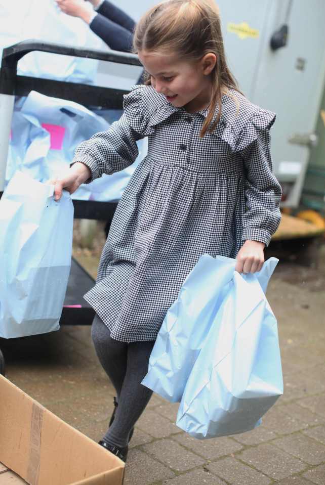 The little girl was also seen handing carrier bags in other candid shots shared by the Duke and Duchess of Cambridge on Instagram