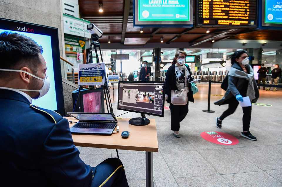  A thermal camera scans the body temperature of commuters arriving at Cardona station