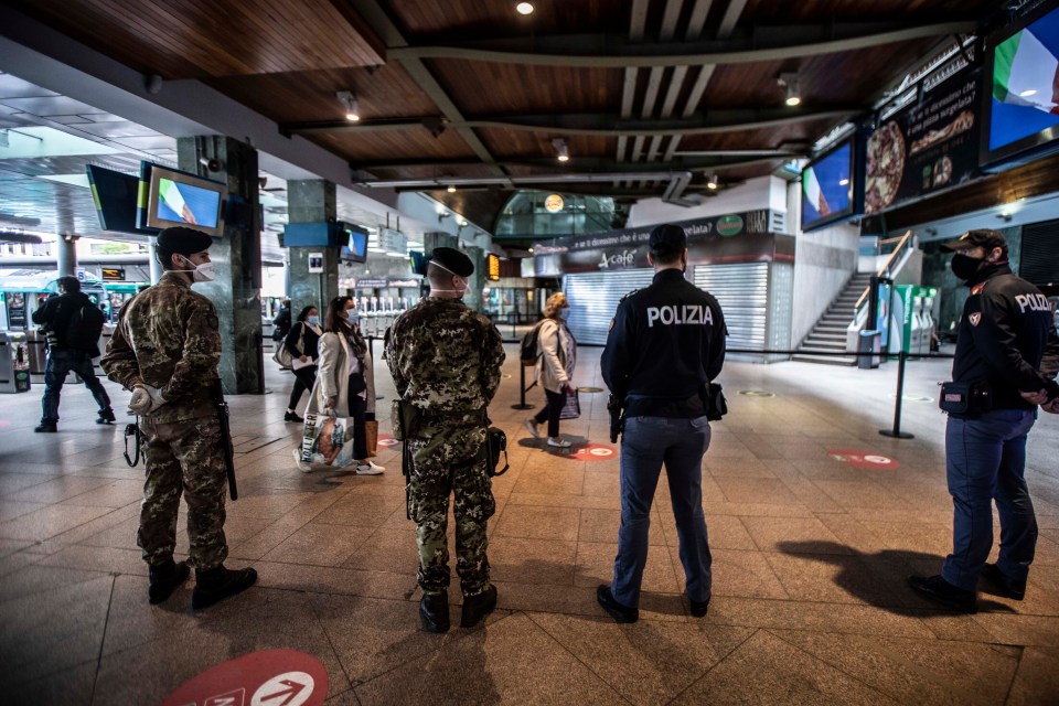  Police and soldiers standing guard at a station