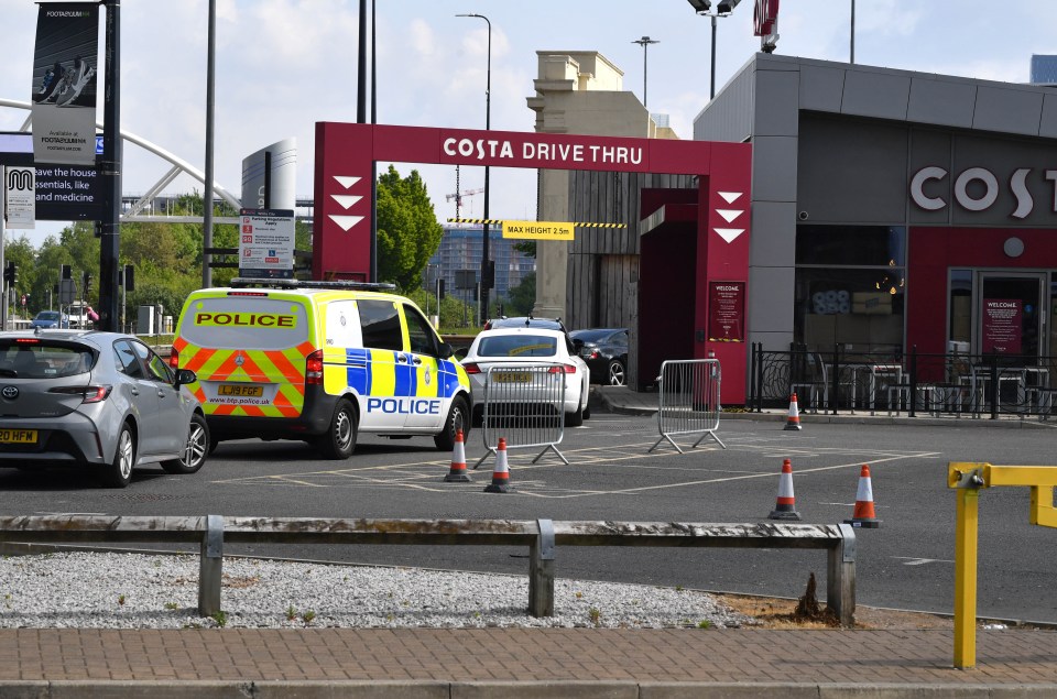 A police van waited in line at the drive-through in Manchester