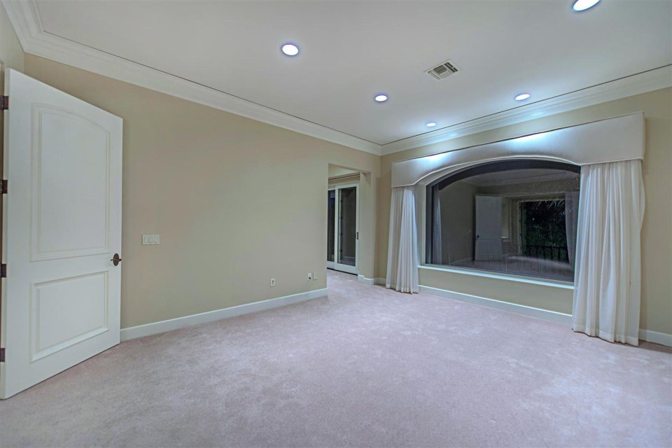 There are six bedrooms, including this spacious master bedroom