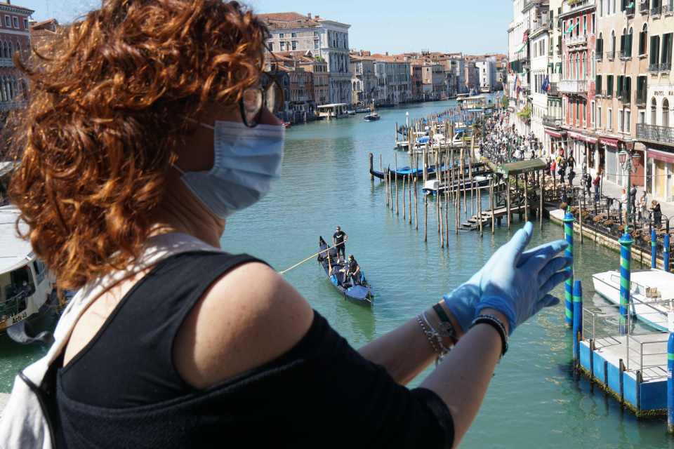  A woman takes part in a flashmob protest of storekeepers asking for the reopening of shops in Venice on May 4