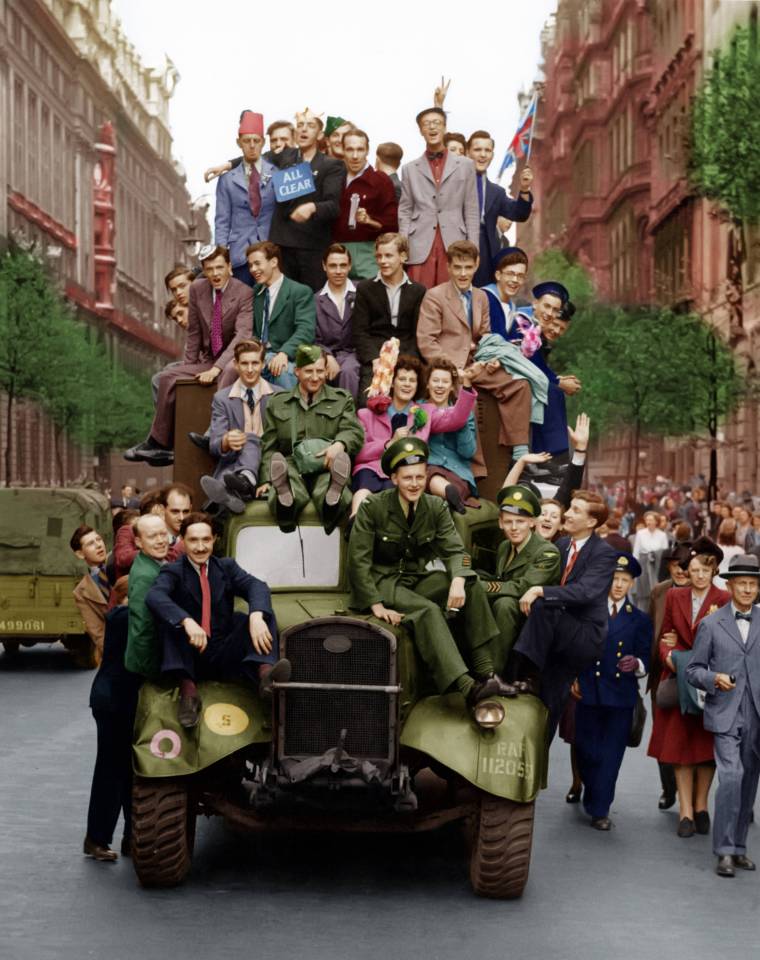  Colourful crowds swarm an RAF truck celebrating VE Day