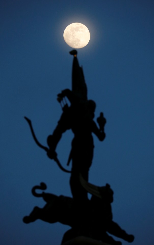  Yesterday's Moon rising behind the Independence Monument in Almaty, Kazakhstan