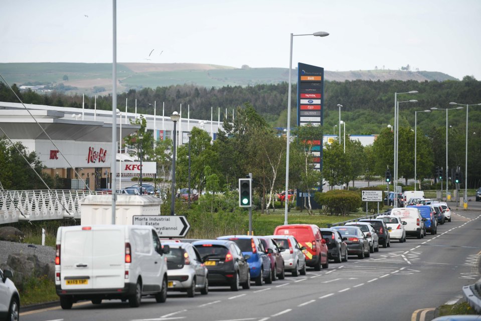  Queues in Swansea wrap around one KFC, despite the chain urging customers to continue to order online still if they can to avoid people making unnecessary journeys