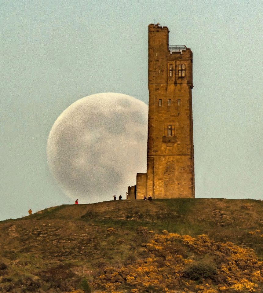  The Flower Moon rises behind Victoria Tower on Castle Hill in Huddersfield, England