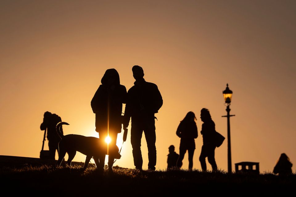  Londoners wait for the Moon rise over Primrose Hill, UK