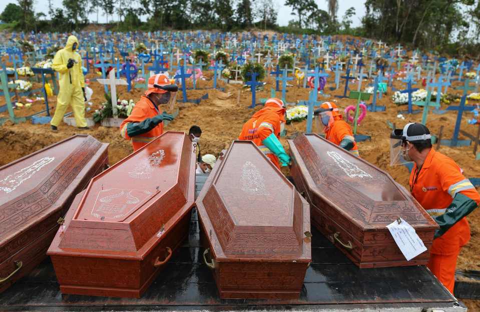  Coffins are unloaded to be buried in a mass grave at the Nossa Senhora cemetery in Manaus, Amazon state, Brazil