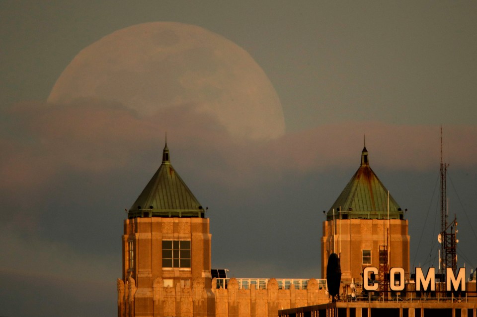  The Moon rising above buildings in downtown Kansas City