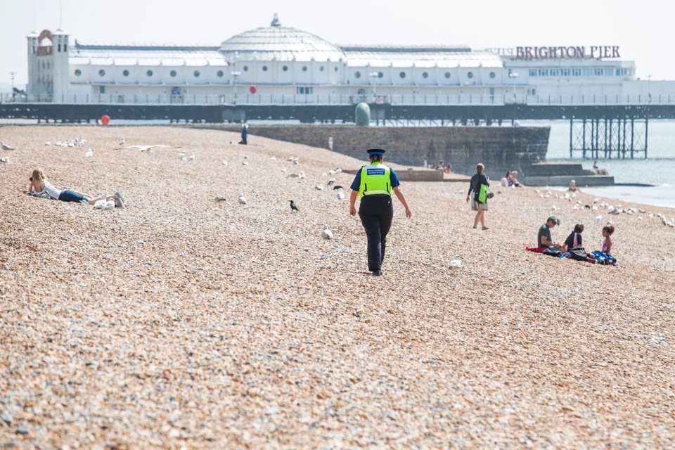  An officer walks along the beach at Brighton