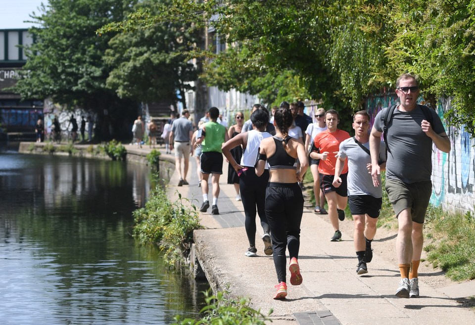  Residents stroll at the Regents canal in east London