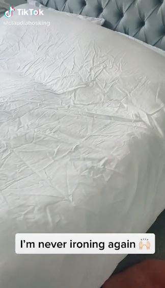 Claudia zoomed in on her creased bedsheets before using the Lenor spray