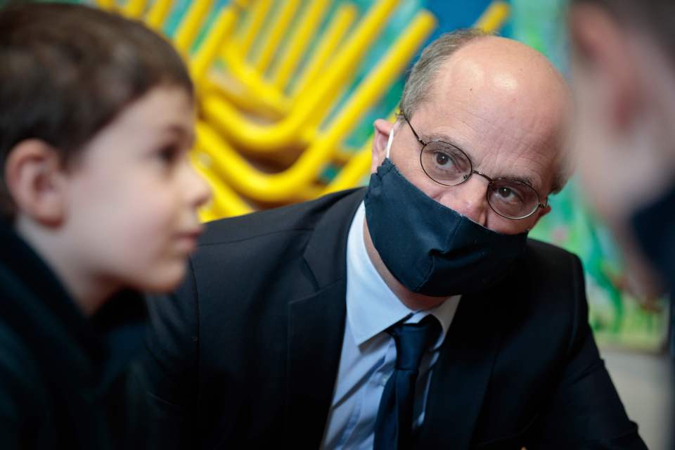  French Education Minister Jean-Michel Blanquer meets children at a school in Paris on May 11, the first day of the reduction of lockdown measures