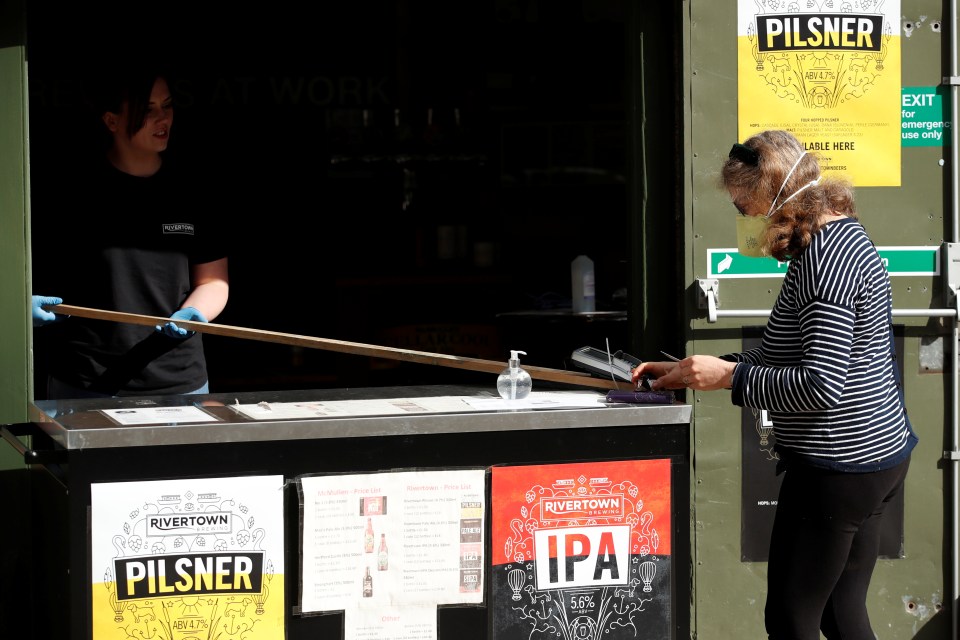 Customers and staff with PPE at the walk and drive-thru at McMullen’s brewery