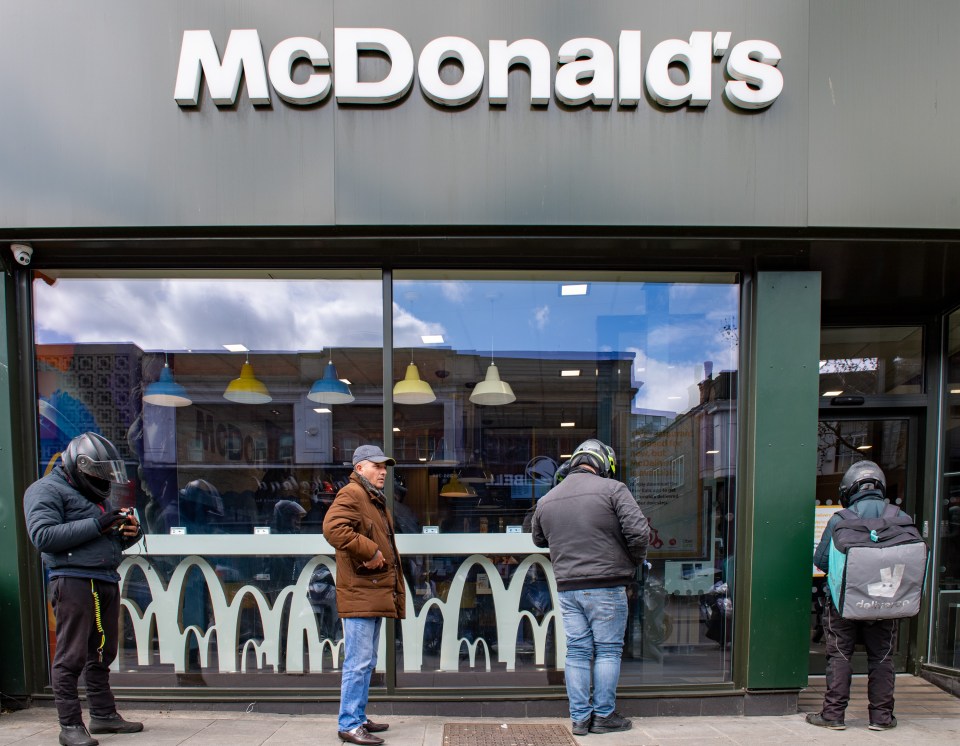  Delivery drivers wait outside the Harrow McDonald's on May 13