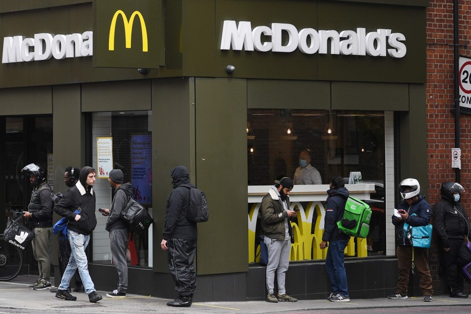 Delivery riders queue up outside a McDonald’s in East London after the restaurant opened for delivery orders only