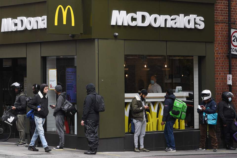  Delivery riders queue up outside a McDonald's in East London after the restaurant opened for delivery orders only