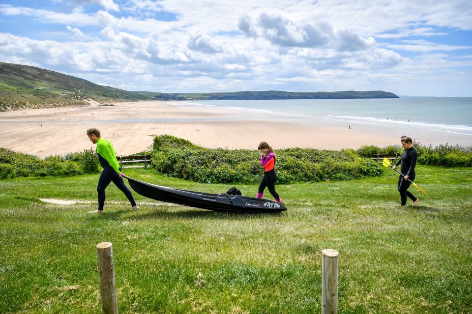 Kyakers wear wetsuits as they make their way towards the beach in Woolacombe, Devon, after the announcement of plans to bring the country out of lockdown