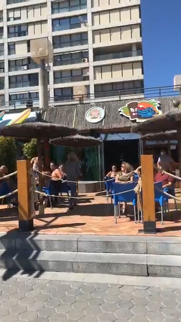  A few locals sit outside in the sun and enjoy a few drinks in the sunshine, but this is a fraction of the crowds the bar usually draws in