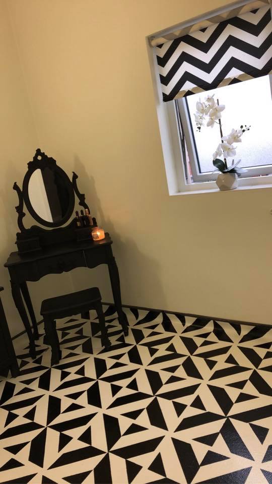 She used white primer and black garage floor paint to create the pattern