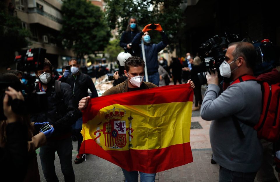  A man holds a Spanish flag during a protest in Madrid