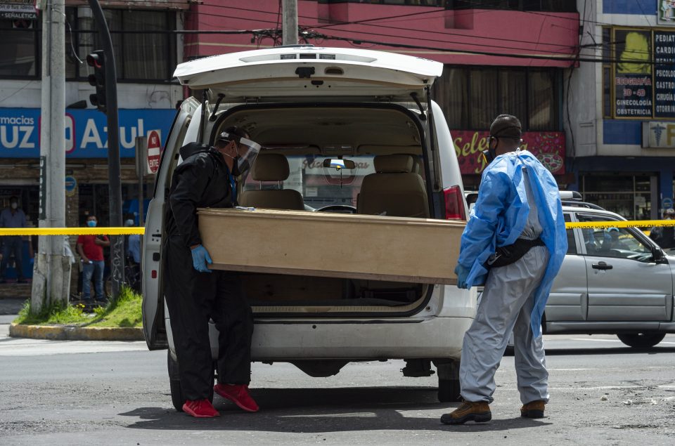  The woman's body in Quito, Ecuador, was put in a coffin and transported away