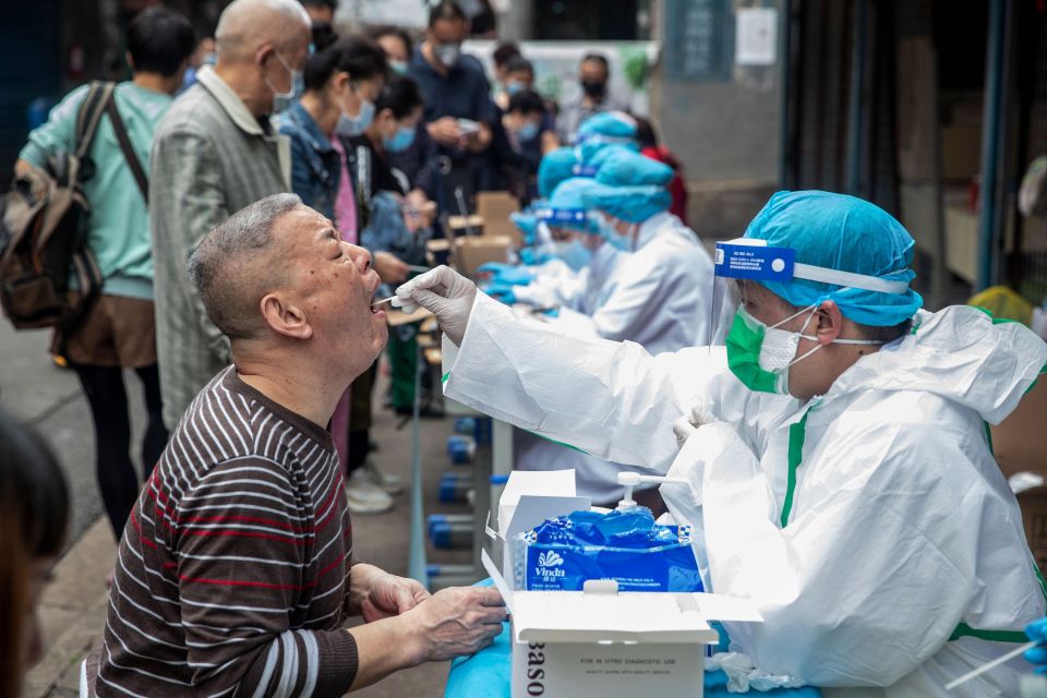  Medical workers take swab samples from residents