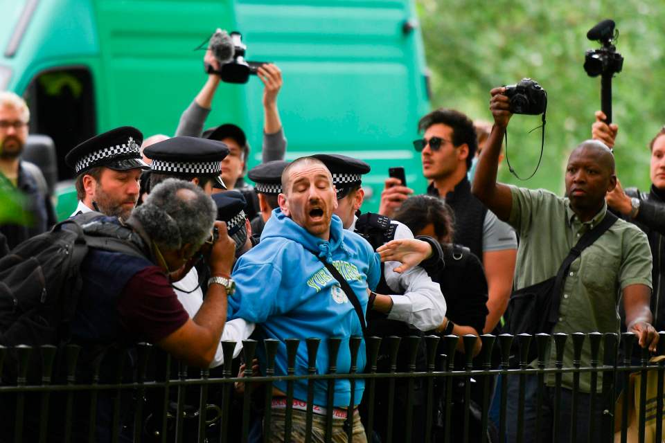  A man is arrested by police as media with cameras and smartphones surround at an anti-coronavirus lockdown demonstration in Hyde Park