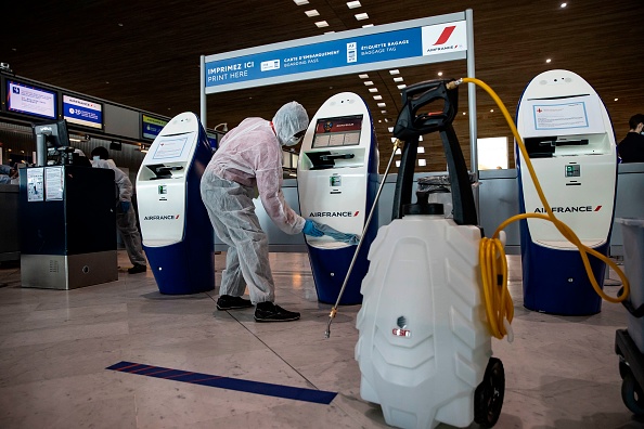  Personnel members clean check-in machines in Terminal 2 of Charles de Gaulle on May 14