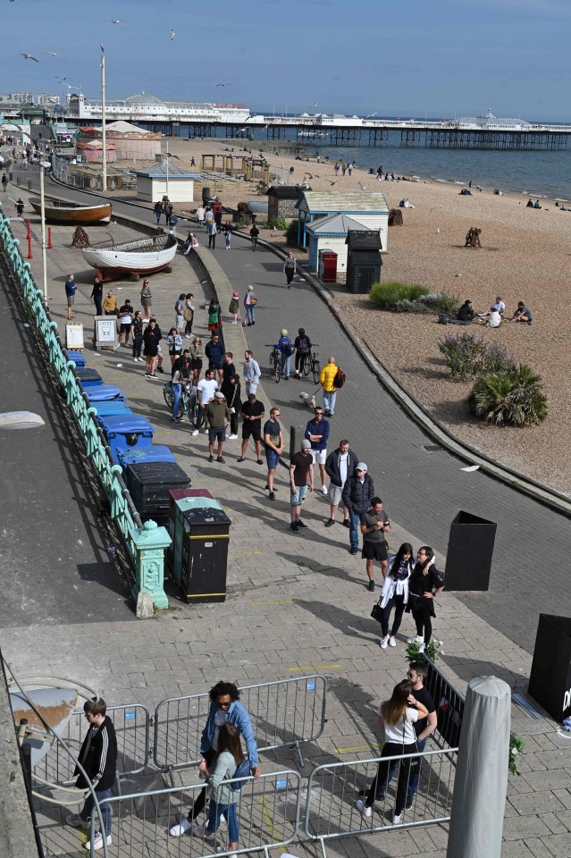 People queue for beer on the beachfront in Brighton following an easing of lockdown rules