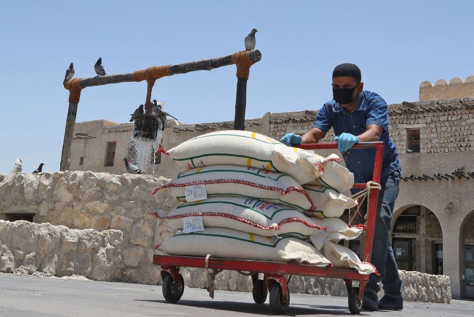  A market porter wears a protective mask at the Souq Waqif bazar in Doha yesterday