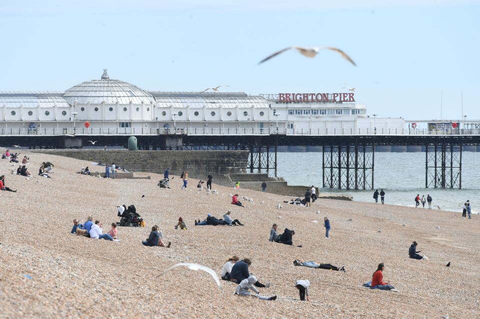  Beach goers flock to Brighton Pier on the first sunny Sunday after lockdown restrictions were eased