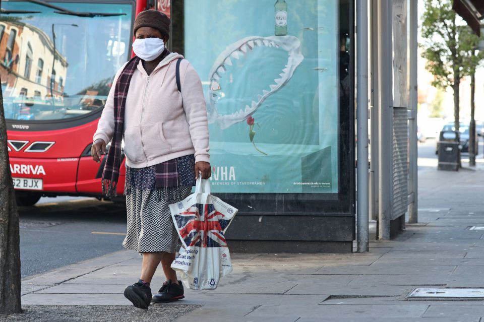  A Brit walks through the streets of London wearing a face mask