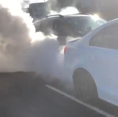  A vehicle revs its engine moments earlier in stopped traffic in social media footage