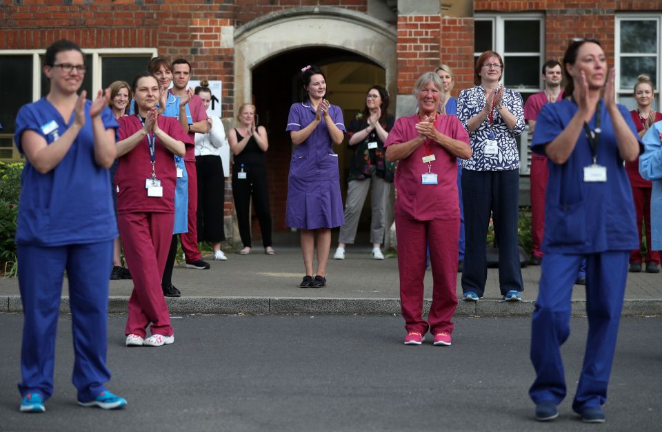  Hospital staff stand outside the Royal Hampshire County Hospital, to join in the applause to salute local heroes last night