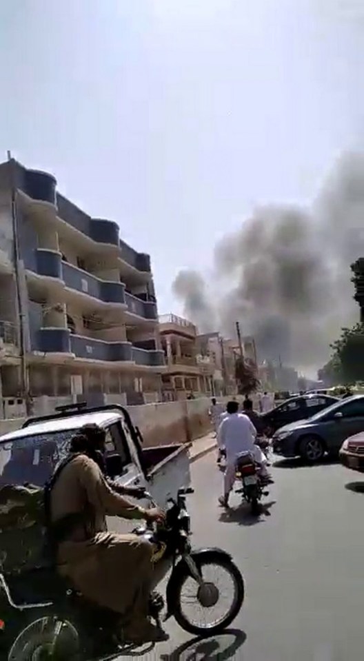  Locals watch as thick smoke billows from what appears to be the crash scene, in the unverified pics