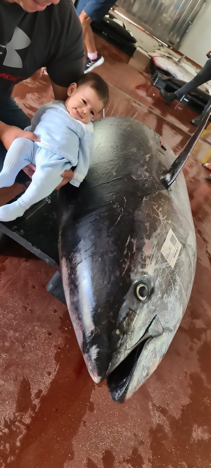  The fisherman's daughter poses next to the sea beast