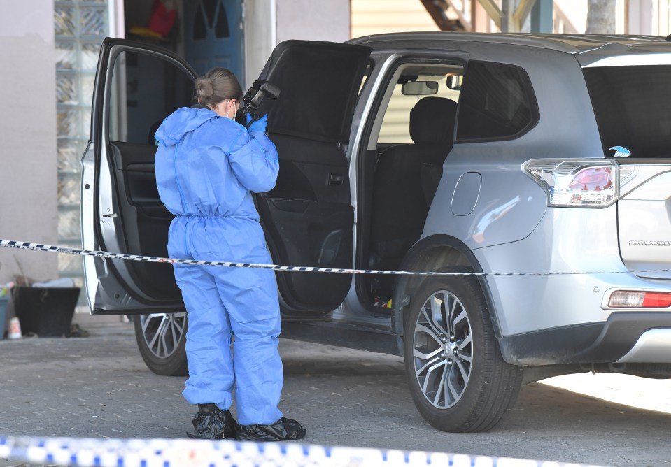  Forensic officers were also examining a vehicle parked in the driveway