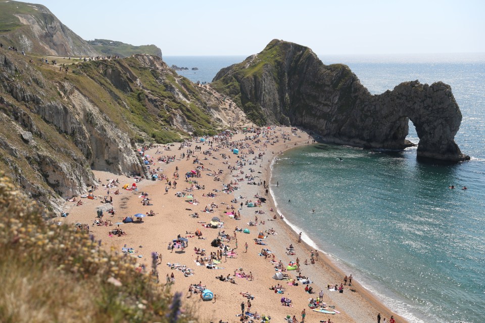 People fill the beach at Durdle Door, near Lulworth, on Sunday