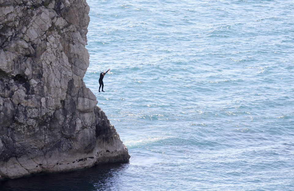 A man recklessly launches himself from the clifftop on Sunday