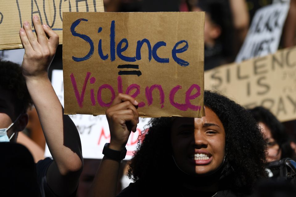  Protesters wave placards during a Black Lives Matter march in London