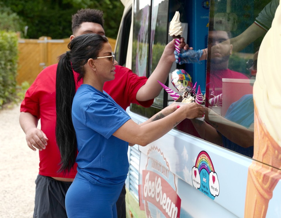  Katie looked effortlessly stylish in blue sports shorts with a matching top, and huge sunglasses