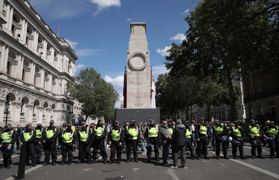  Police form a barrier in front of activists surrounding the Cenotaph