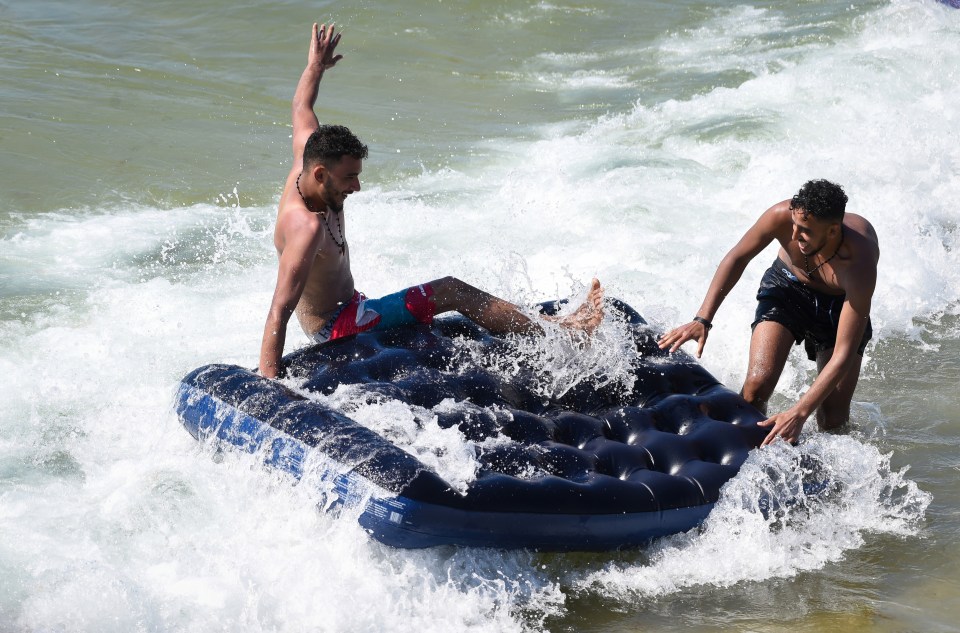 Pals attempt to ride the waves in Bournemouth